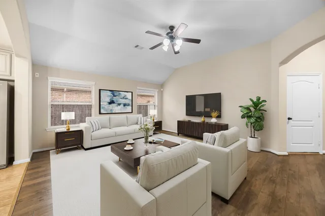 a living room with furniture and a flat screen tv