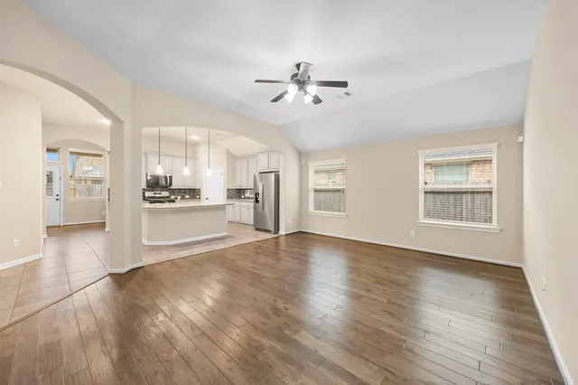 a view of a kitchen with wooden floor and a kitchen