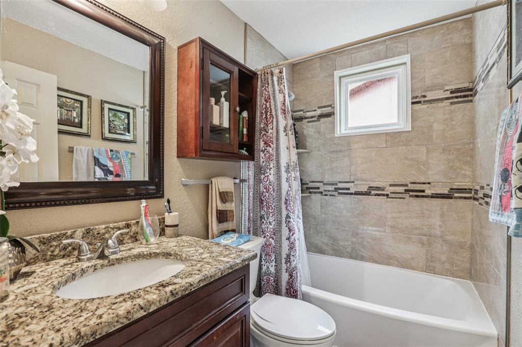 5575 58th Street North Kenneth City, FL 33709 - Photo 18 of 31 a bathroom with a granite countertop sink toilet and shower
