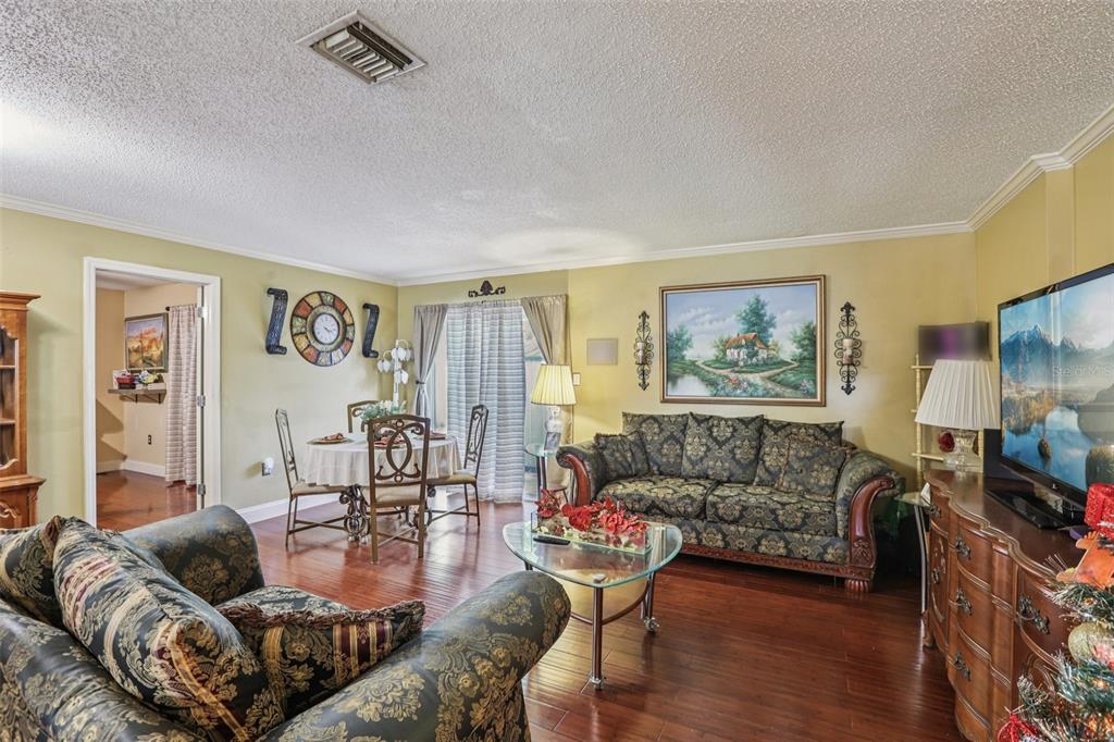 5575 58th Street North Kenneth City, FL 33709 - Photo 4 of 31 a living room with furniture and a wooden floor