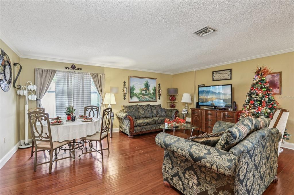 5575 58th Street North Kenneth City, FL 33709 - Photo 6 of 31 a living room with furniture and a flat screen tv