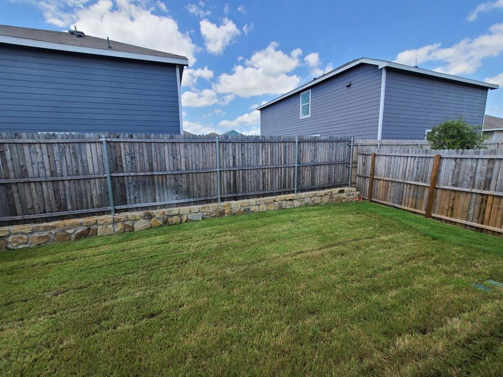 4009 Renee Drive Dallas, TX 75227 - Photo 14 of 15 a view of a backyard with a small cabin and wooden fence