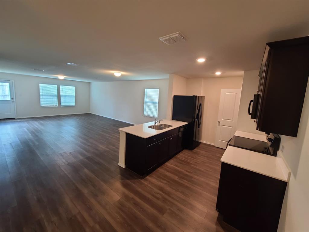 4009 Renee Drive Dallas, TX 75227 - Photo 4 of 15 a living room with furniture and a flat screen tv