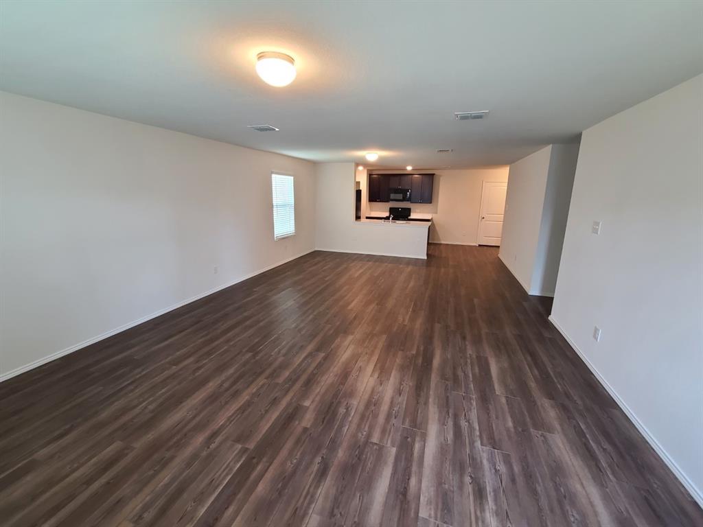 4009 Renee Drive Dallas, TX 75227 - Photo 6 of 15 a view of empty room with wooden floor