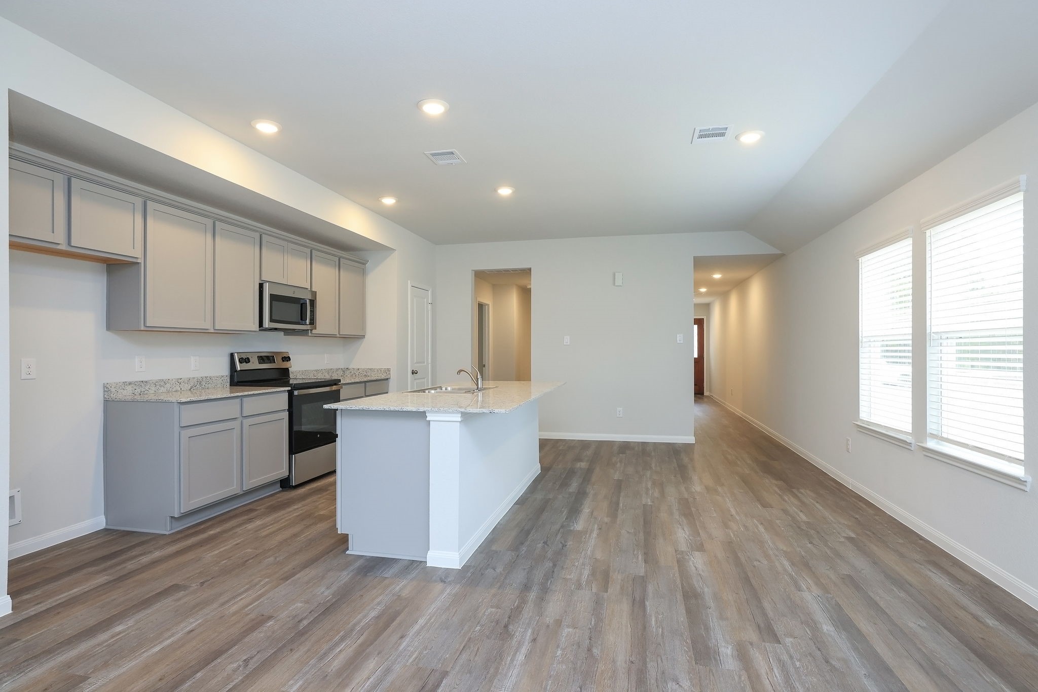 26439 Lake Shore Drive Hempstead, TX 77445 - Photo 11 of 45 a kitchen with a sink wooden floor stainless steel appliances and cabinets