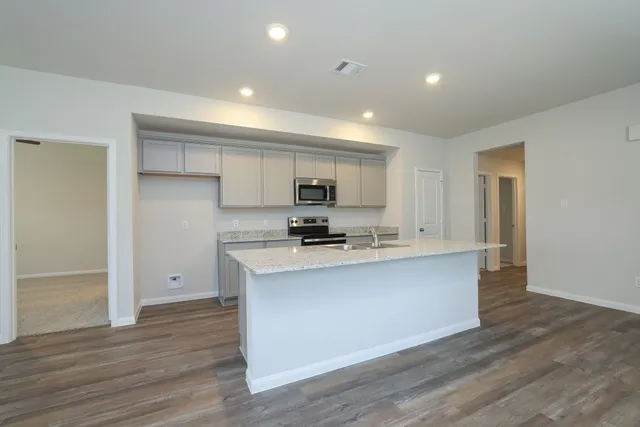 a view of kitchen with sink microwave and refrigerator