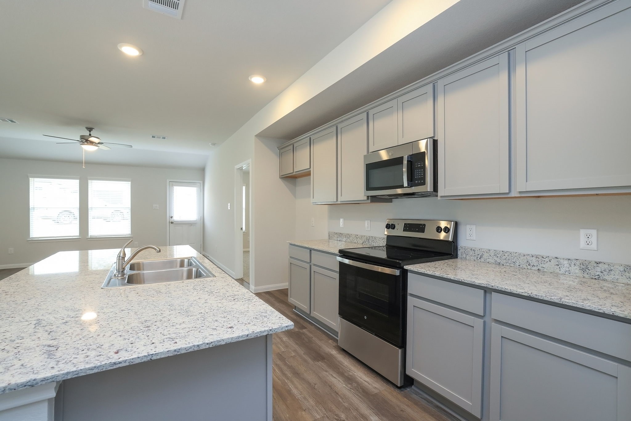 26439 Lake Shore Drive Hempstead, TX 77445 - Photo 45 of 45 a kitchen with granite countertop stainless steel appliances a stove sink microwave and cabinets