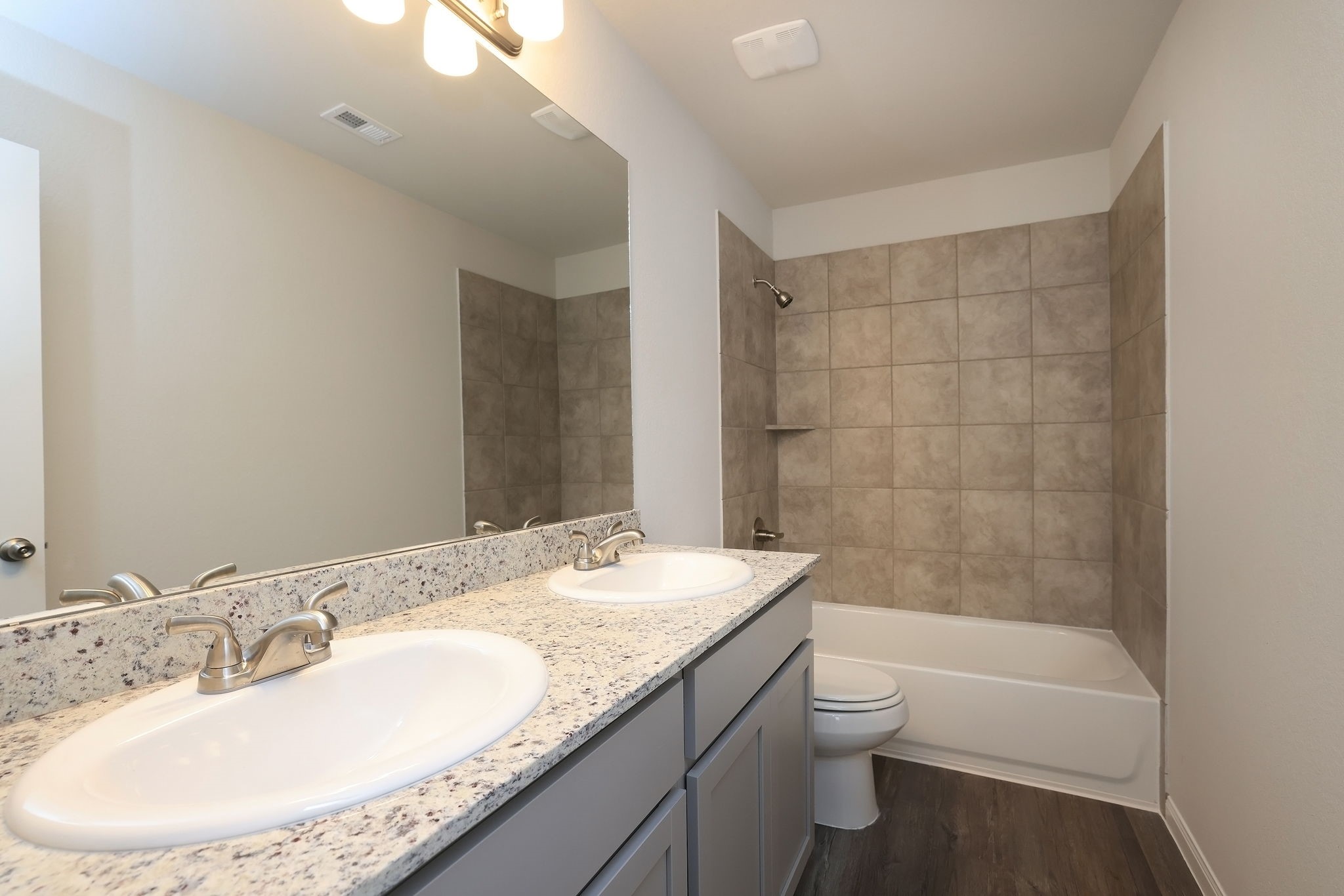 26439 Lake Shore Drive Hempstead, TX 77445 - Photo 18 of 45 a bathroom with a granite countertop sink a toilet and bathtub