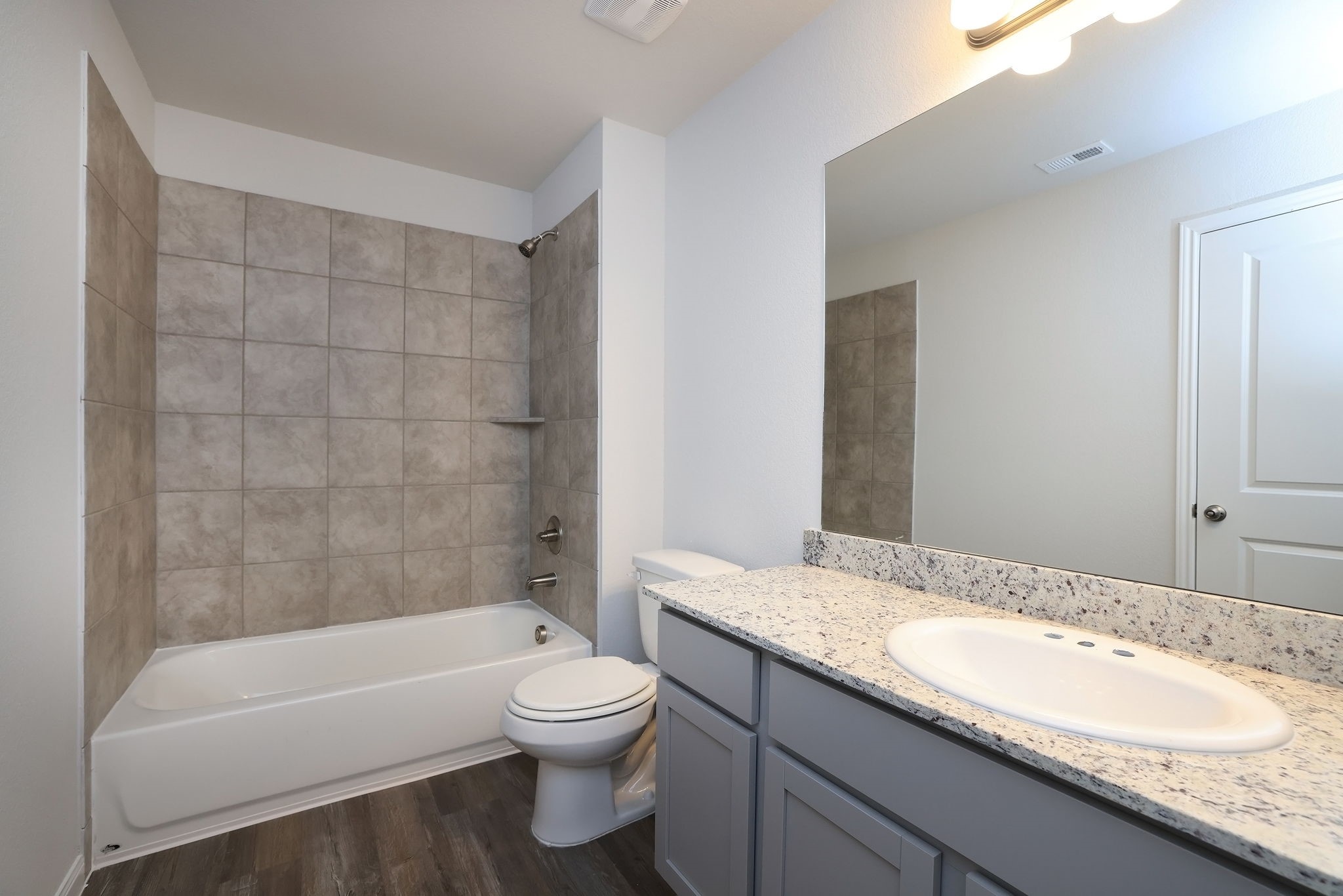 26439 Lake Shore Drive Hempstead, TX 77445 - Photo 21 of 45 a bathroom with a granite countertop bathtub shower sink mirror vanity and toilet