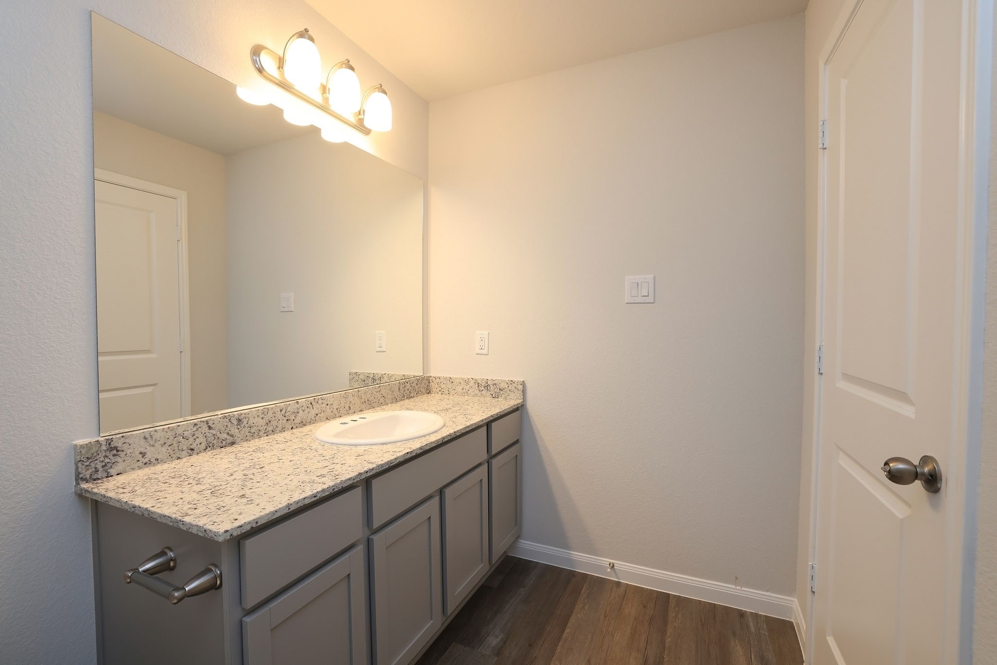 26439 Lake Shore Drive Hempstead, TX 77445 - Photo 22 of 45 a bathroom with a granite countertop sink and a mirror