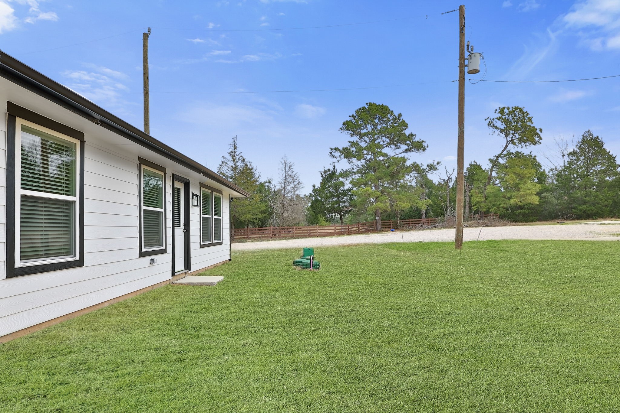 26439 Lake Shore Drive Hempstead, TX 77445 - Photo 32 of 45 a view of a house with backyard and a tree