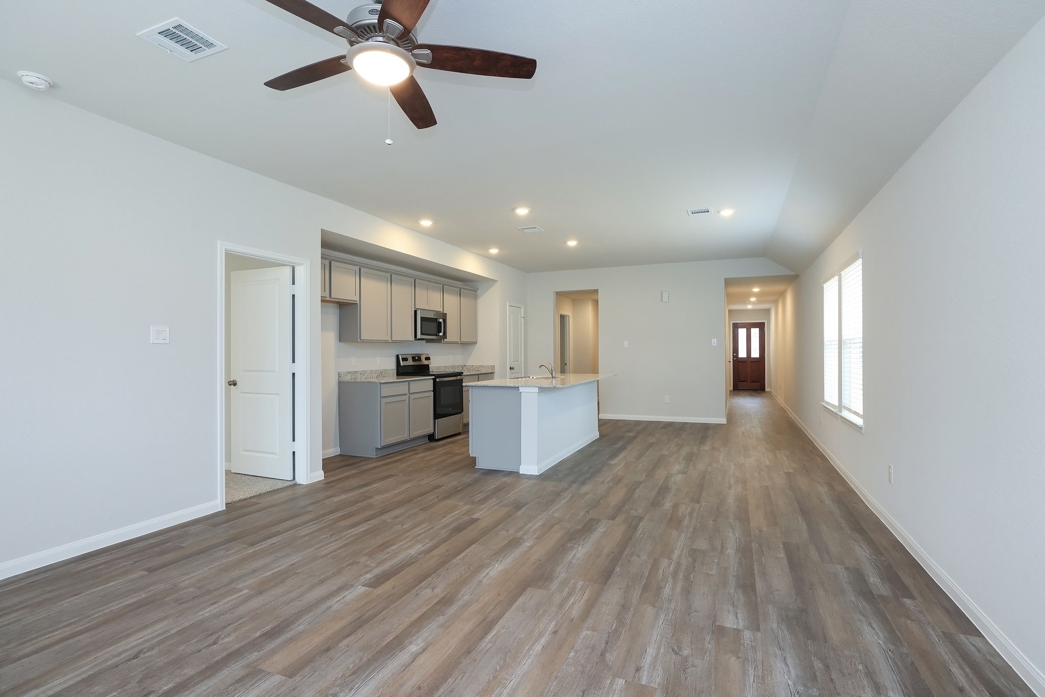 26439 Lake Shore Drive Hempstead, TX 77445 - Photo 5 of 45 a kitchen with stainless steel appliances kitchen island hardwood floor sink and window