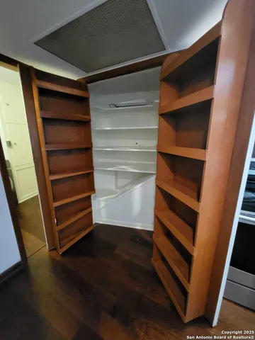 a view of walk in closet with empty racks