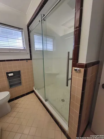 a bathroom with a shower and toilet