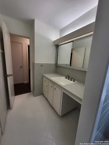 a bathroom with a sink and mirror