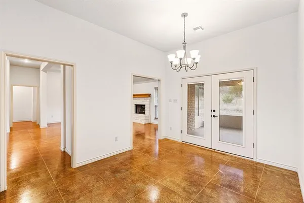 a view of a livingroom with wooden floor and a chandelier