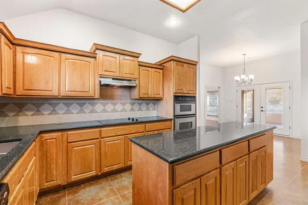a kitchen with stainless steel appliances granite countertop a sink and a cabinets