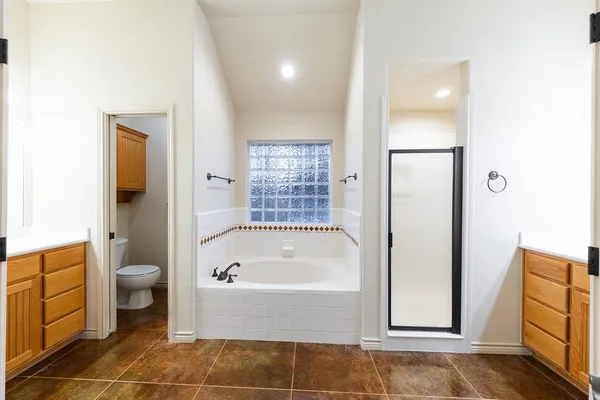 a bathroom with a bathtub and a toilet