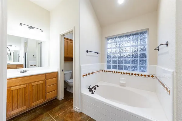 a bathroom with a bathtub a sink a vanity and a shower
