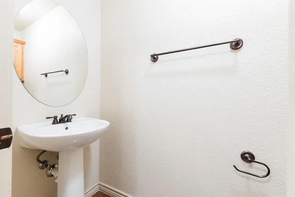 a bathroom with a sink a mirror and a shower