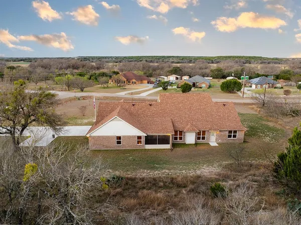 a view of a house with yard and sitting area