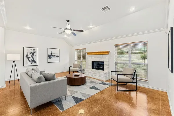 a living room with furniture fireplace and window