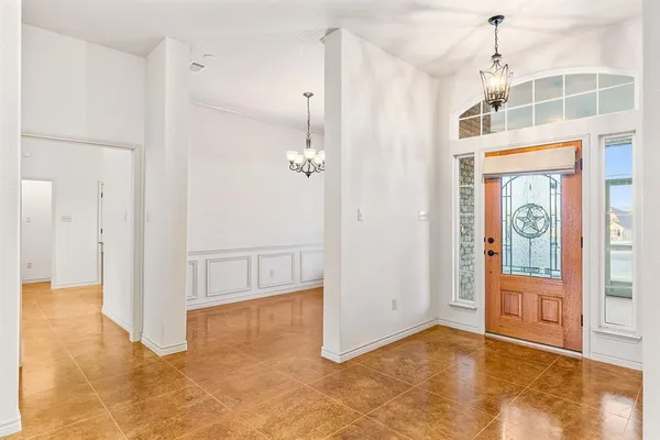 a view of an empty room with cabinet and a window