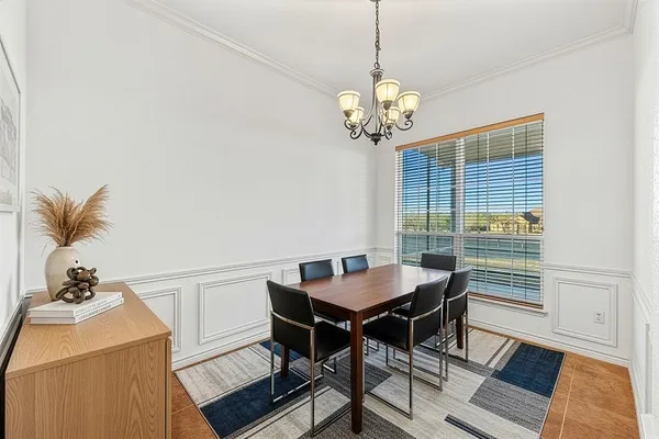 a view of a dining room with a table and chairs