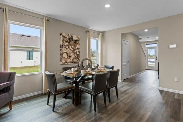 a view of a dining room with furniture and wooden floor
