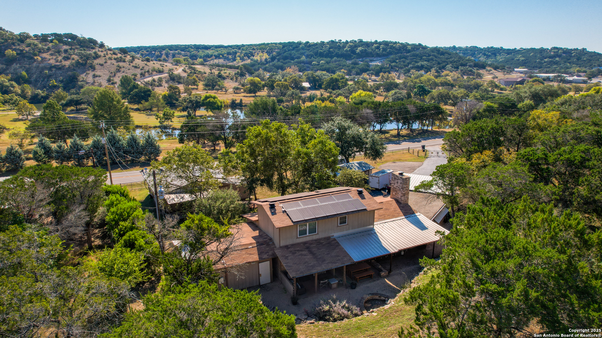 an aerial view of a house with a yard