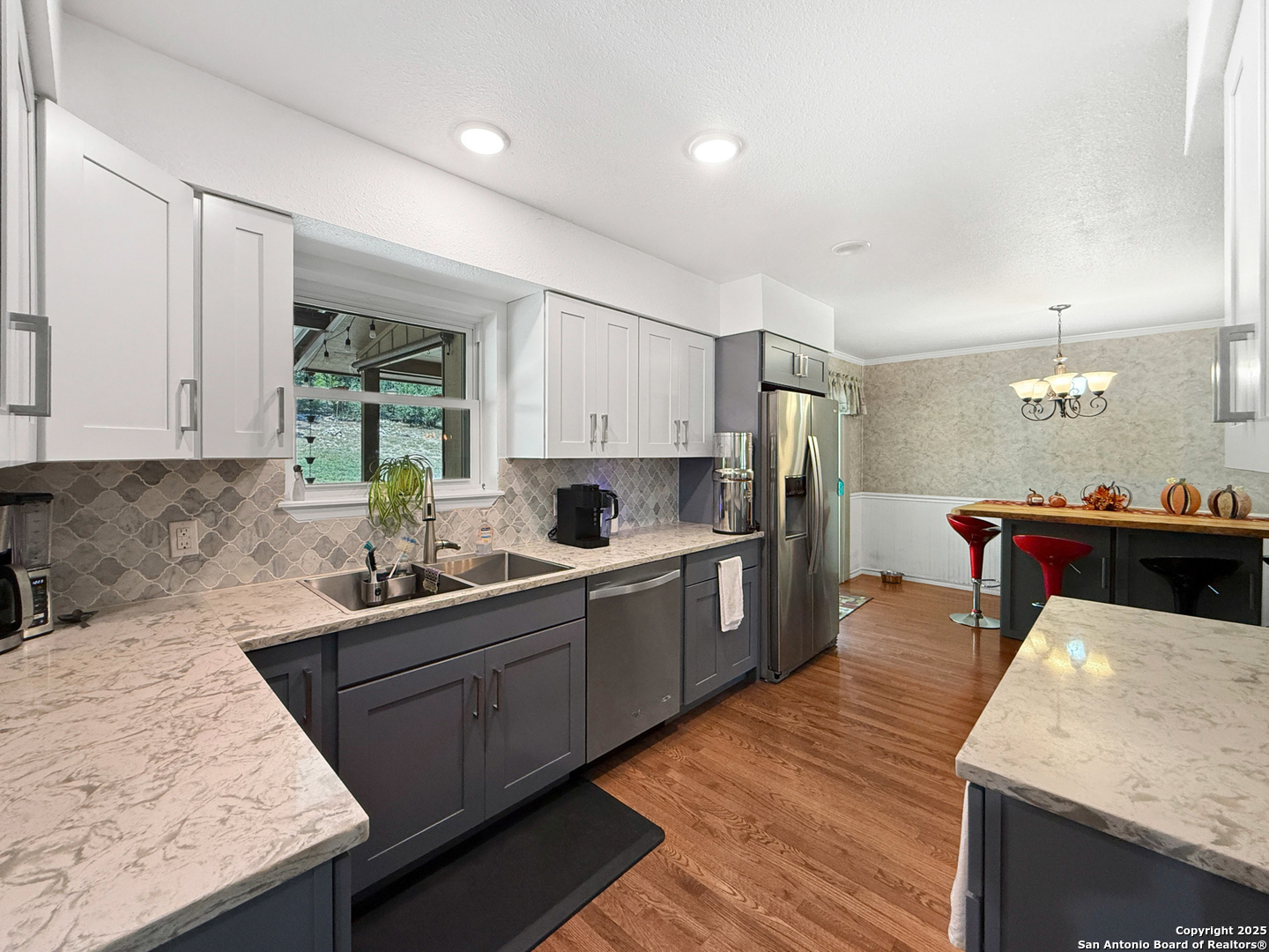 1406 Harper Road Kerrville, TX 78028 - Photo 13 of 33 a kitchen with sink cabinets and wooden floor