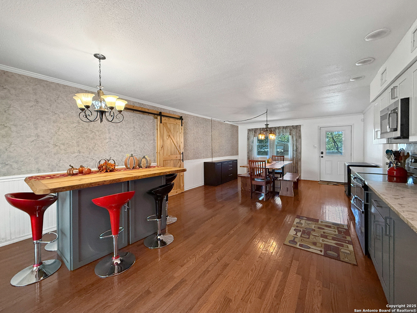 1406 Harper Road Kerrville, TX 78028 - Photo 15 of 33 a living room with furniture and kitchen dining table chairs