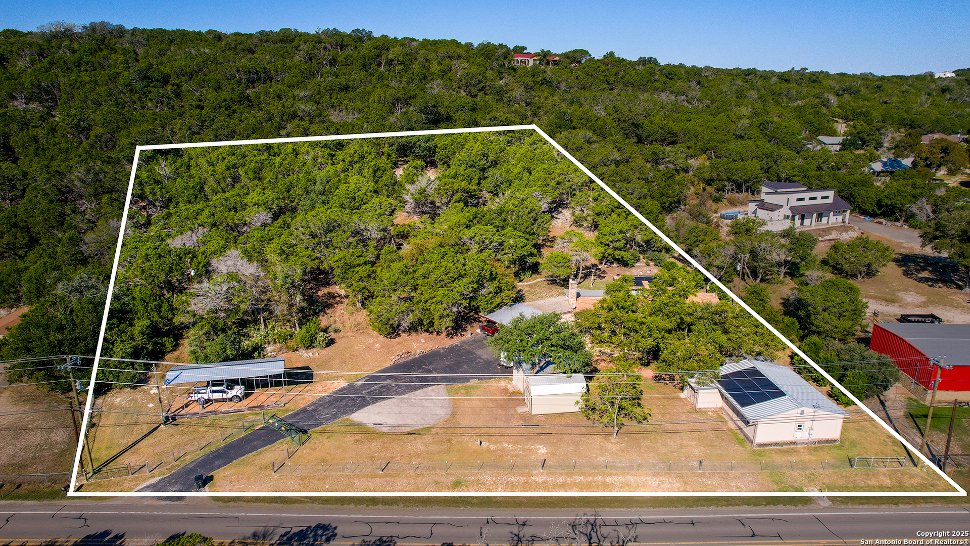 1406 Harper Road Kerrville, TX 78028 - Photo 2 of 33 a view of a balcony with floor to ceiling windows