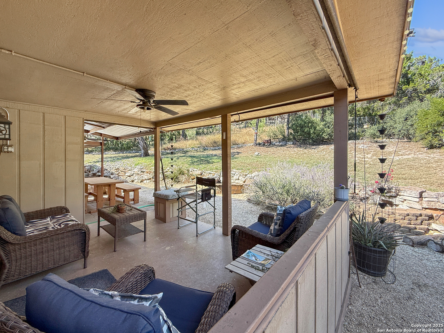 1406 Harper Road Kerrville, TX 78028 - Photo 27 of 33 a living room with furniture and a floor to ceiling window