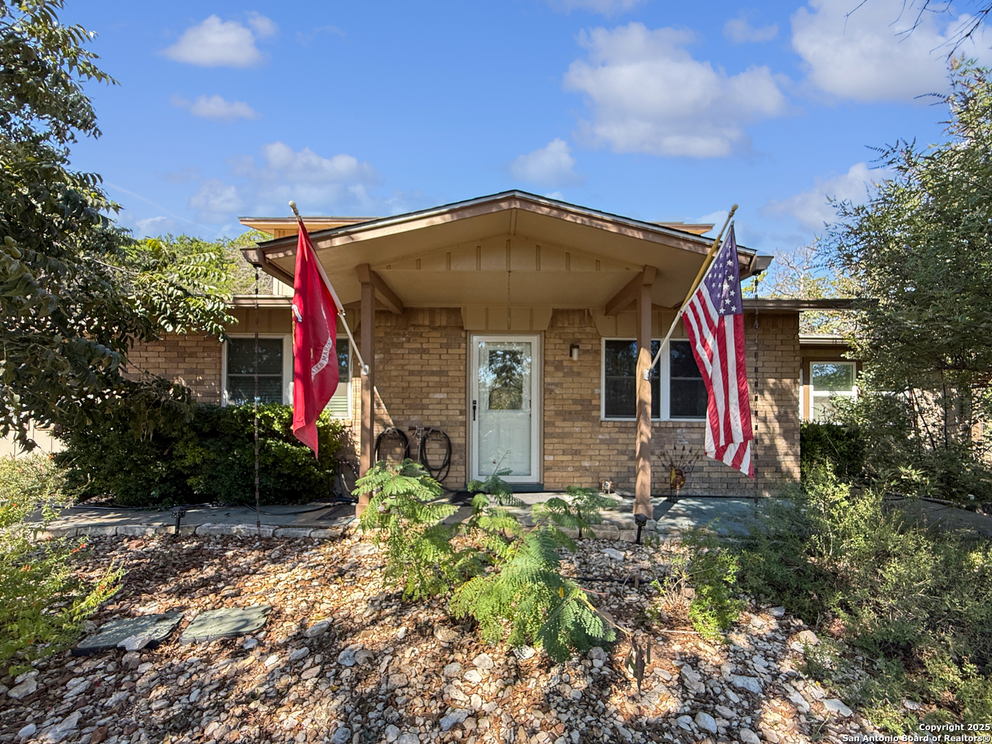 1406 Harper Road Kerrville, TX 78028 - Photo 3 of 33 a front view of a house with a yard