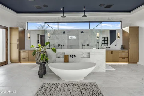 a spacious bathroom with a double vanity sink and a mirror