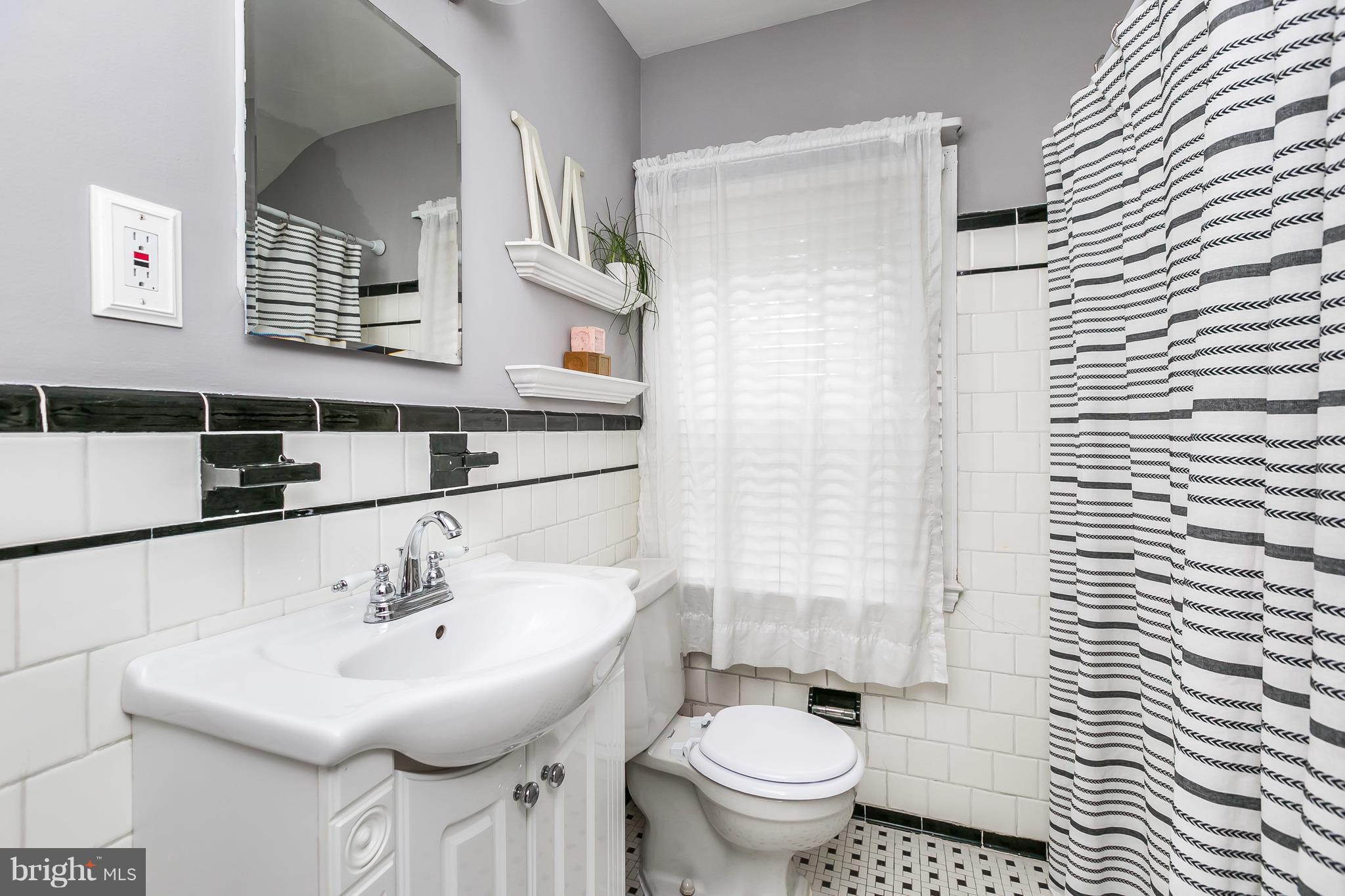 40 Dunvegan Road Baltimore, MD 21228 - Photo 19 of 26 White vanity w/ classic black & white tile