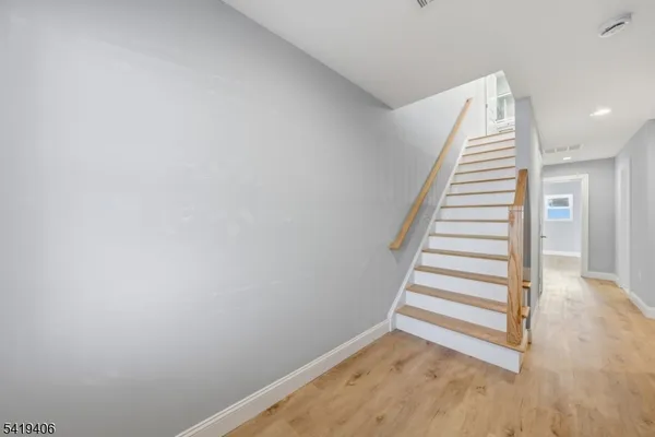 a view of a hallway with stairs
