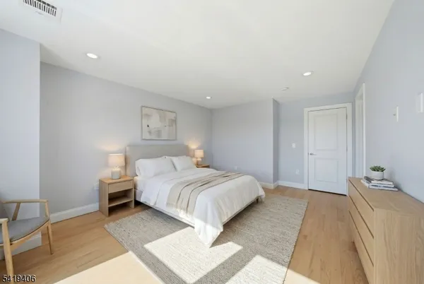 a bed room with a bed and a lamp