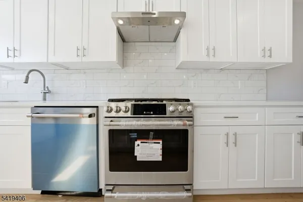 a stove top oven sitting inside of a kitchen