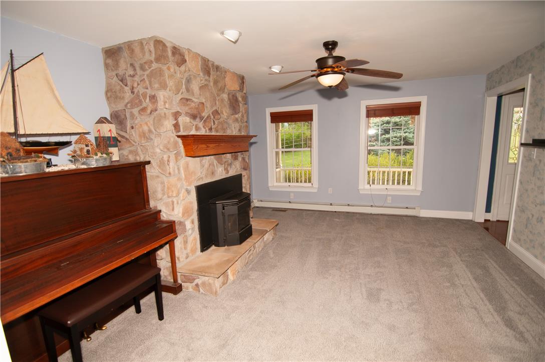 2202 High Meadow Road Coopersburg, PA 18036 - Photo 16 of 41 A floor-to-ceiling stone fireplace serves as the focal point in this comfortable living space.