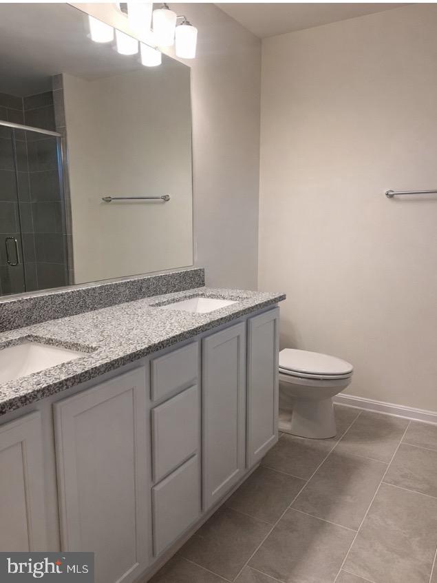 178 North Regulator Drive Cambridge, MD 21613 - Photo 8 of 18 a bathroom with a granite countertop sink a toilet and a mirror