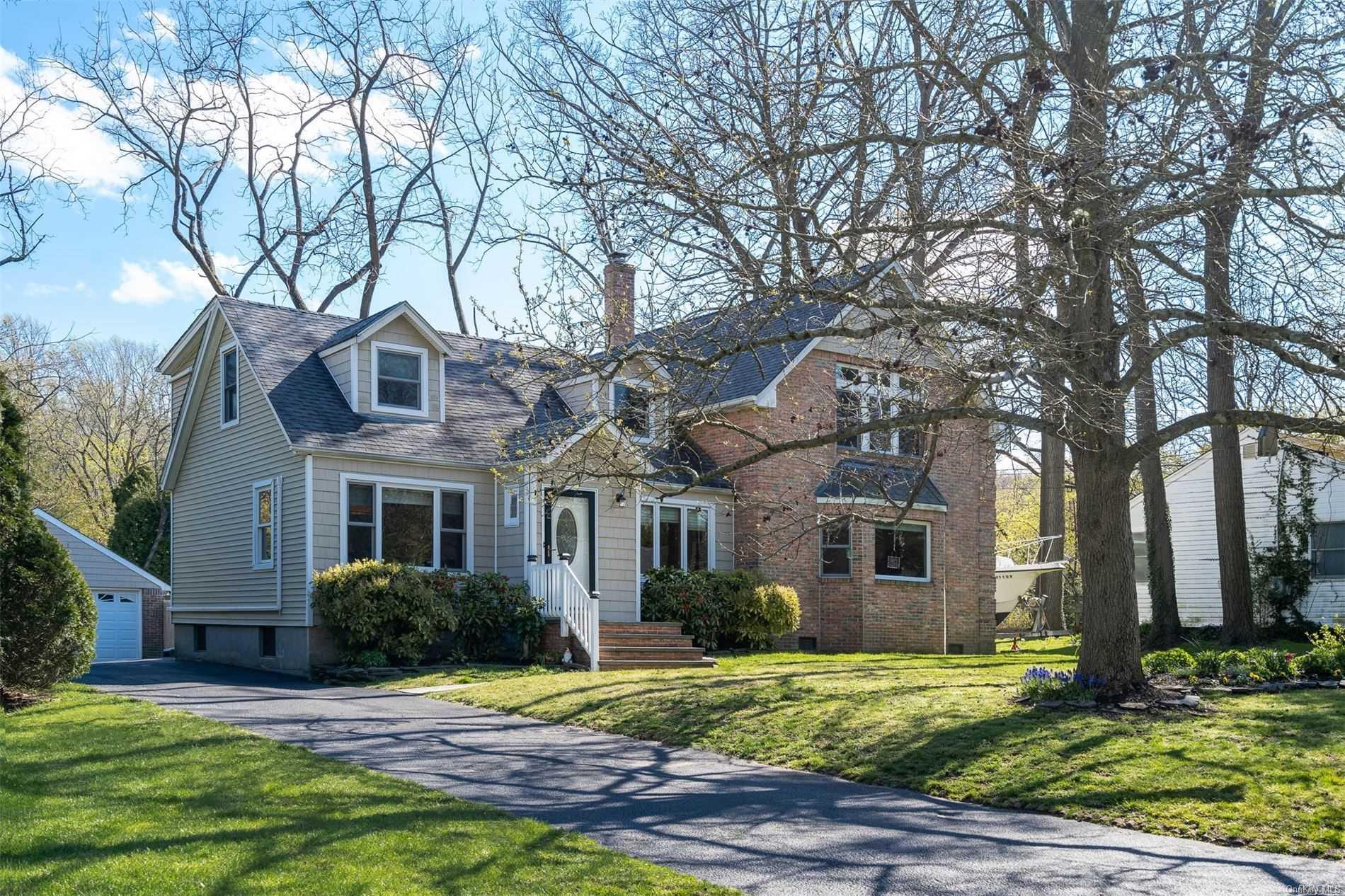 16 Harned Drive Centerport, NY 11721 - Photo 1 of 1 a front view of a house with a yard