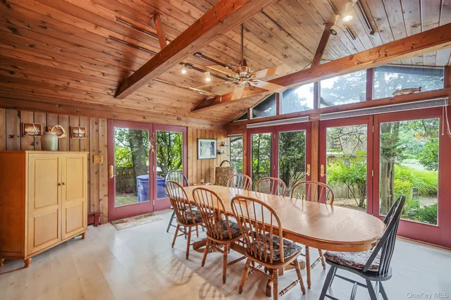 a spacious bedroom with a large bed a flat screen tv and balcony view