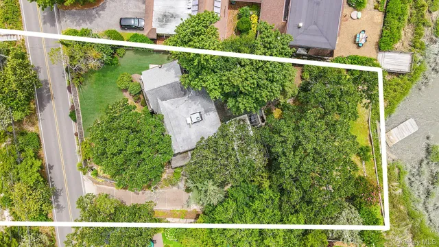 a living room with furniture a wooden floor and next to a window