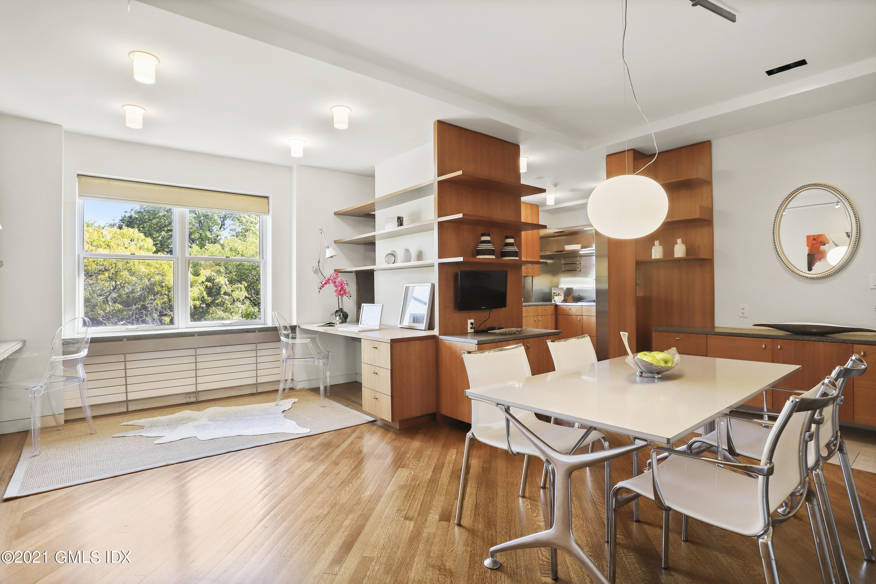 636 Steamboat Road, Unit 4A SOUTH Greenwich, CT 06830 - Photo 16 of 30 a view of a dining room with furniture window and wooden floor
