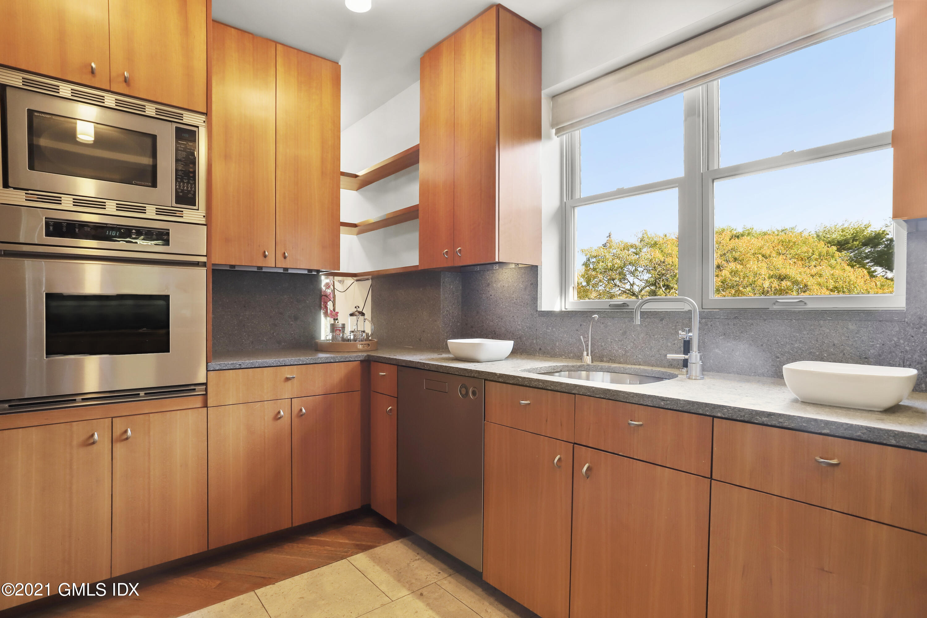 636 Steamboat Road, Unit 4A SOUTH Greenwich, CT 06830 - Photo 19 of 30 a kitchen with stainless steel appliances a sink a stove and a microwave