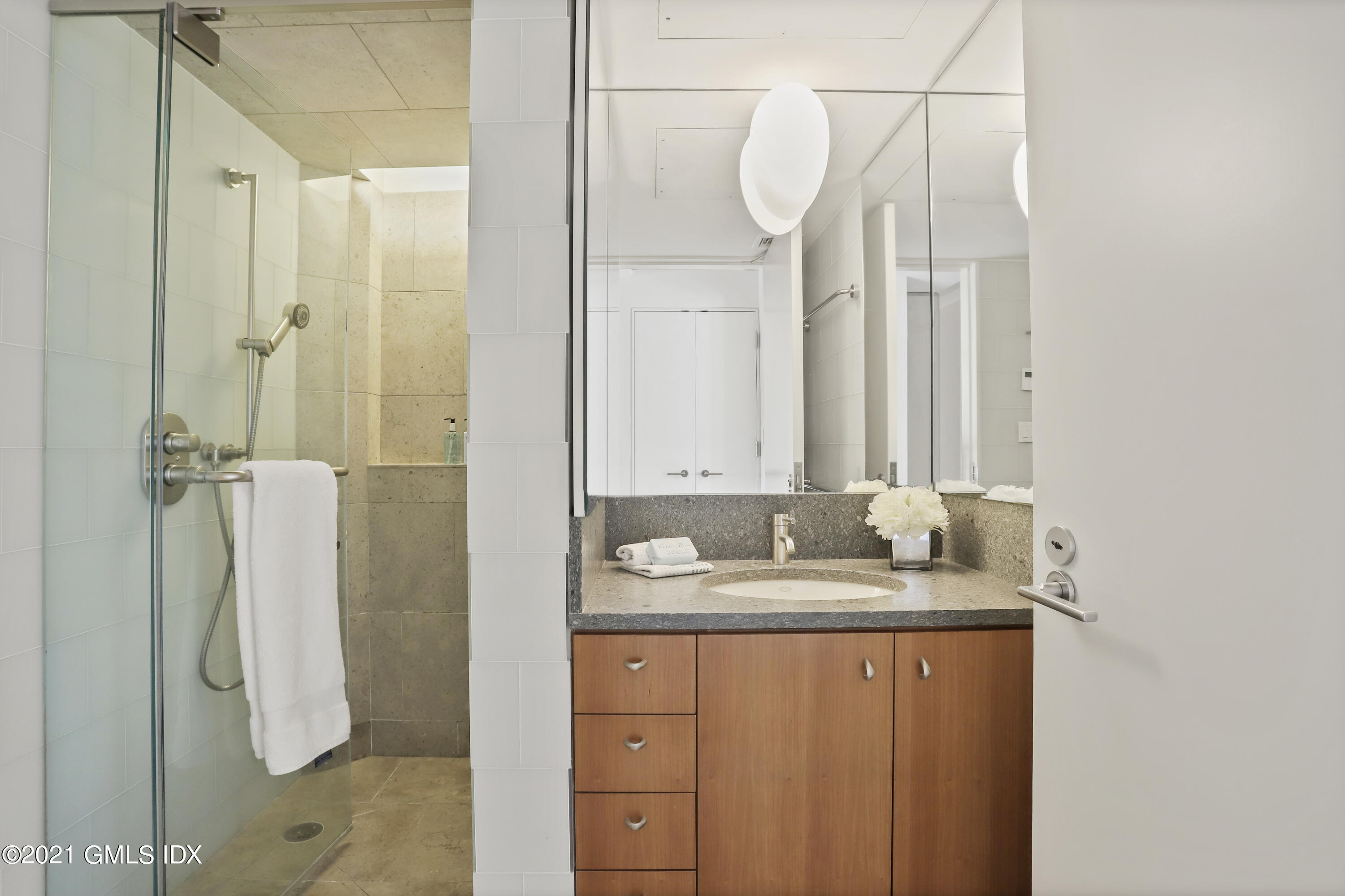 636 Steamboat Road, Unit 4A SOUTH Greenwich, CT 06830 - Photo 25 of 30 a bathroom with a granite countertop sink and a mirror