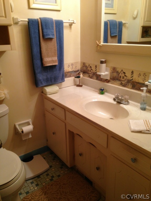 16131 Sandwave Road Chester, VA 23831 - Photo 12 of 24 a bathroom with a toilet sink and mirror