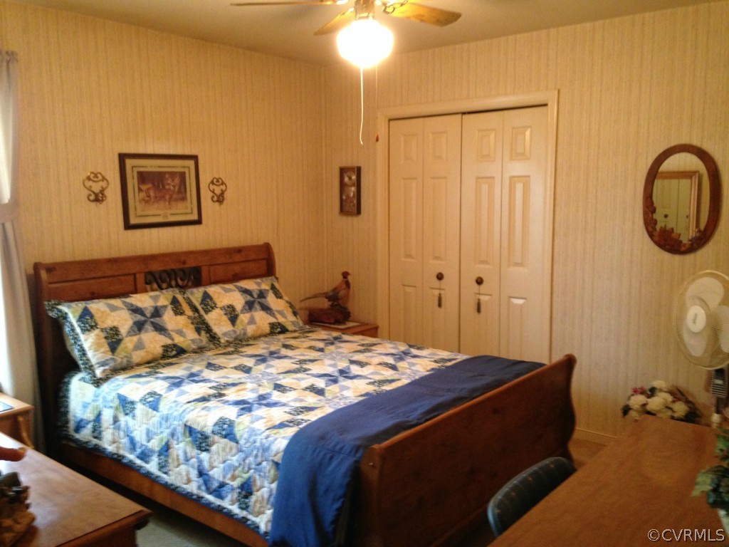 16131 Sandwave Road Chester, VA 23831 - Photo 13 of 24 a bedroom with a bed and a chandelier